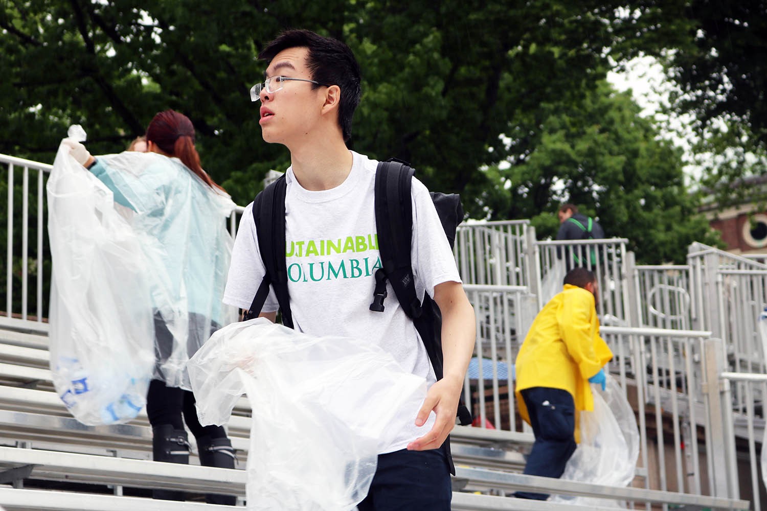 EcoReps collecting water bottles in the bleachers after Commencement