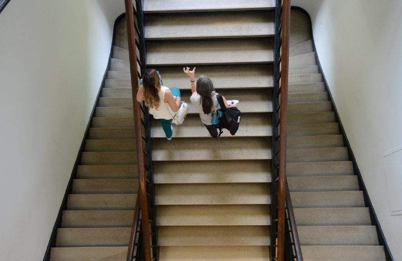Students walking up stairs in an building